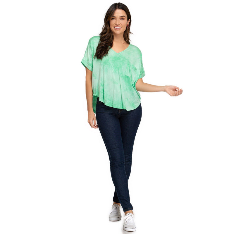 Load image into Gallery viewer, Full-body shot of a woman smiling in a light green tie-dye top with a V-neck, casually tucked into jeans, embodying a relaxed, chic vibe.
