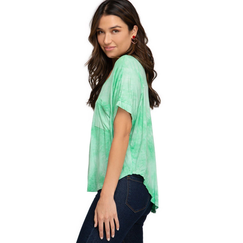 Load image into Gallery viewer, Three-quarter rear view of a woman in a light green tie-dye top with a V-neck and drop shoulders, highlighting the airy and loose fit.

