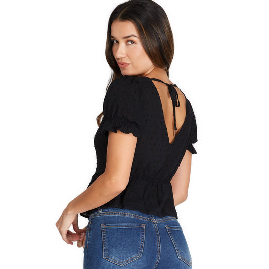 Back view of a black Short Sleeve V-neck Ruched Blouse featuring a stylish tie detail at the neck and an alluring keyhole cutout, paired with denim.