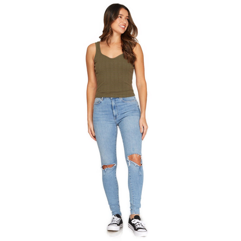 Load image into Gallery viewer, Full-body image of a woman wearing an olive green ribbed crop top with a scoop neckline, complemented by ripped blue jeans and casual sneakers.
