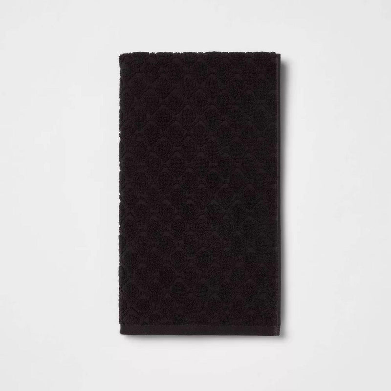 Load image into Gallery viewer, One plush black bath towel laid flat, displaying the quality cotton material and textured pattern that provides both comfort and style.
