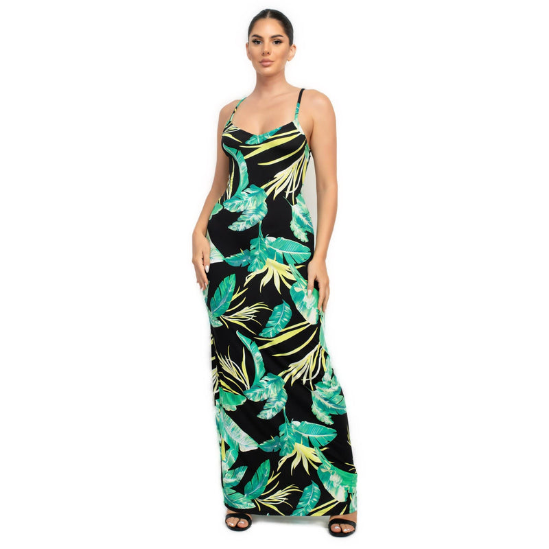 Load image into Gallery viewer, Front view of a chic black maxi dress adorned with vibrant green tropical leaves, ideal for a statement summer wardrobe piece.
