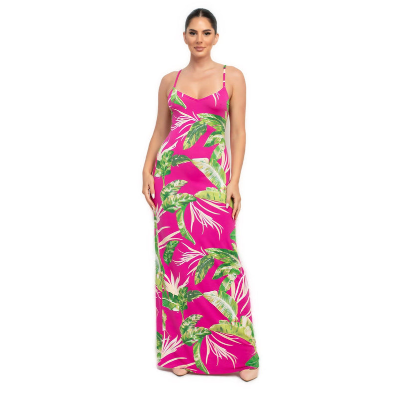 Load image into Gallery viewer, Model wearing a fuchsia tropical print maxi dress, featuring bright pink and green leaf patterns for a playful summer look.

