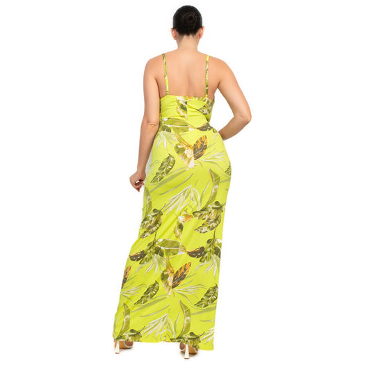 Woman from behind wearing a lime green tropical print bodycon maxi dress, highlighting the figure-embracing design and vivid leaf patterns.