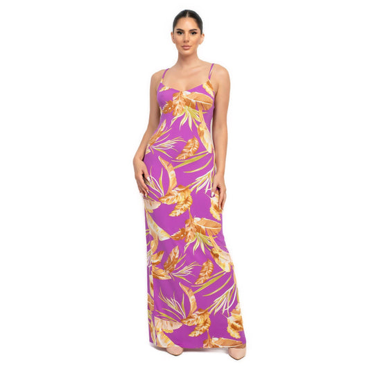 Model wearing a purple tropical print maxi dress, combining bold color with a summery floral pattern for a striking effect.