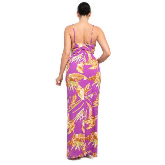 Rear view of a purple bodycon maxi dress with a lush tropical print, showing the dress's sleek and chic style.