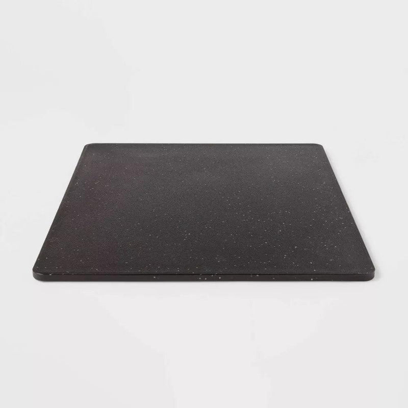 Load image into Gallery viewer, Angled view of the black polygranite cutting board, emphasizing its thick, sturdy build and the speckled granite-like finish that adds elegance to functionality.
