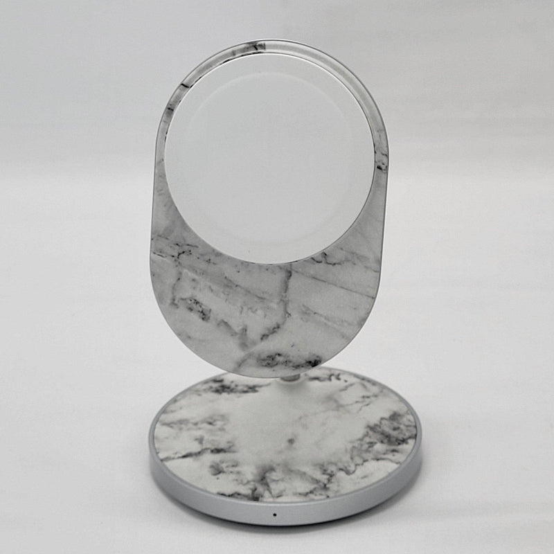 Load image into Gallery viewer, A modern MagSafe wireless charging stand with a circular white charging pad and marbled gray base, positioned upright on a white background.
